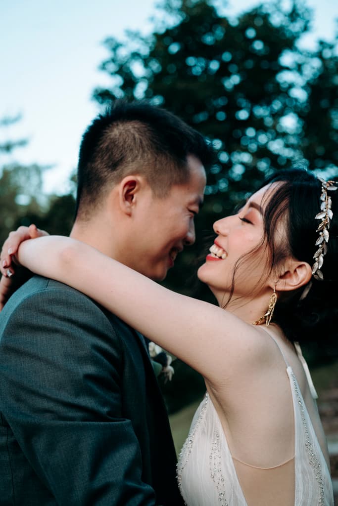 portrait of the smiling wedding couple in the garden of Villa Bled in Bled in Slovenia