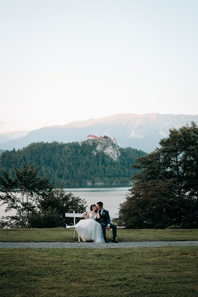 wedding couple kissing in front of a stunning background at Lake Bled in Slovenia